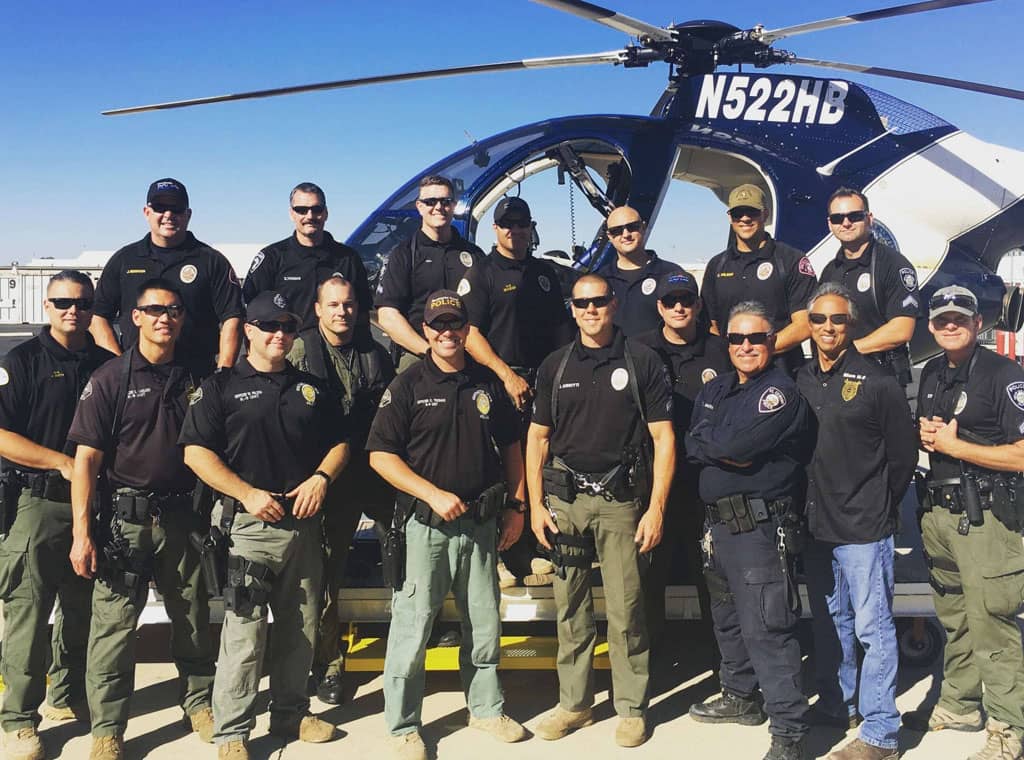 man-k9-police-squad-posing-for-photo-in-front-of-helicopter-v2