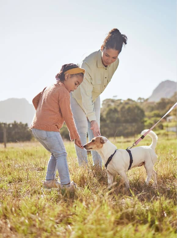 53555102_dog-park-and-pet-family-with-child-mother-and-father-in-nature-or-a-grass-field-for-outdoor-wellness-bonding-love-and-care-of-animal-or-puppy